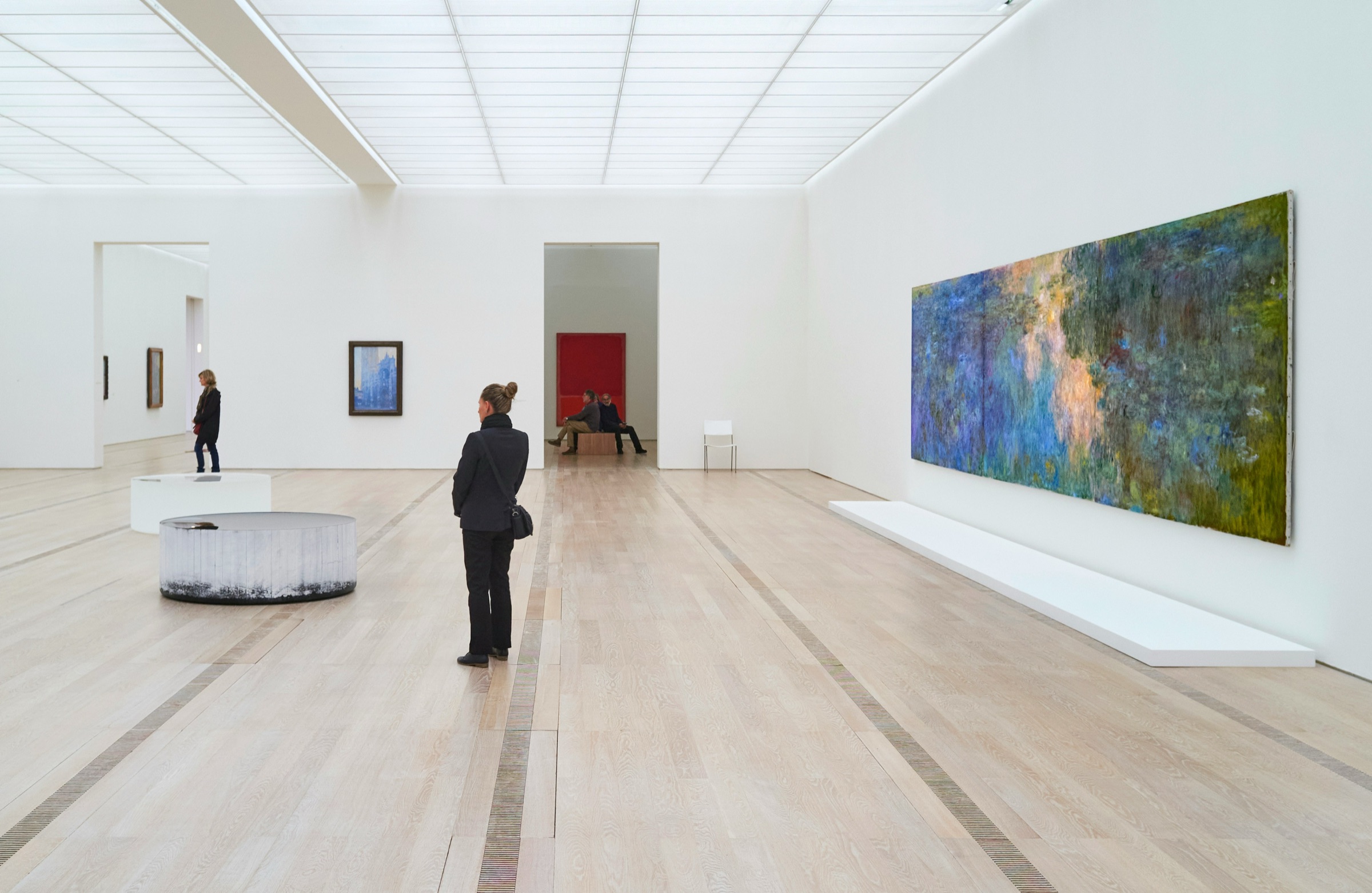 Visitors in a bright, minimal gallery space